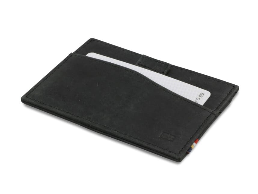 Front view of Leggera Card Holder Brushed in Brushed Black with a pull tab with a card.