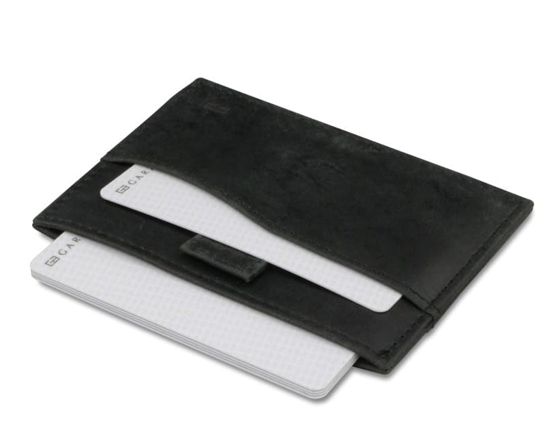 Open Leggera Card Holder Brushed in Brushed Black with cards pulling out.