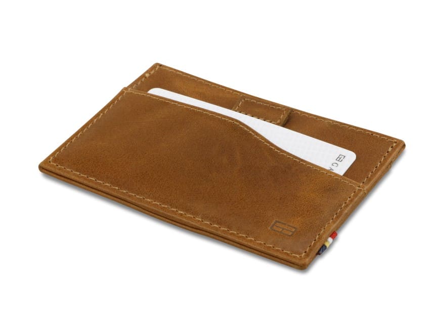 Front view of Leggera Card Holder Brushed in Brushed Cognac with a pull tab with a card.