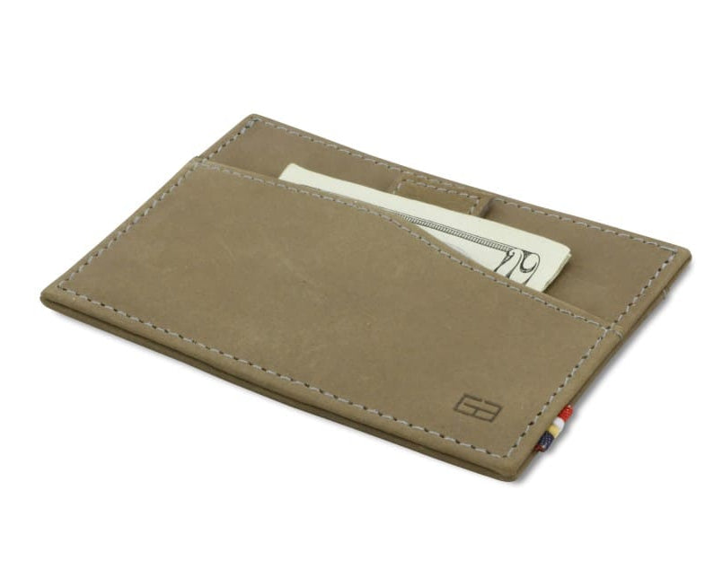 Front view of Leggera Card Holder Vintage in Metal Grey with a pull tab with money.