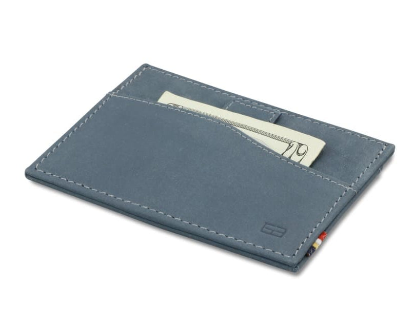 Front view of Leggera Card Holder Vintage in Sapphire Blue with a pull tab with money.