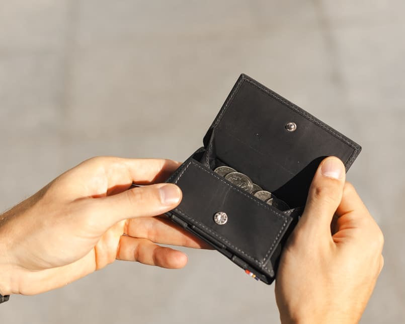 hand holding the coin pocket of the Cavare Magic Coin Wallet