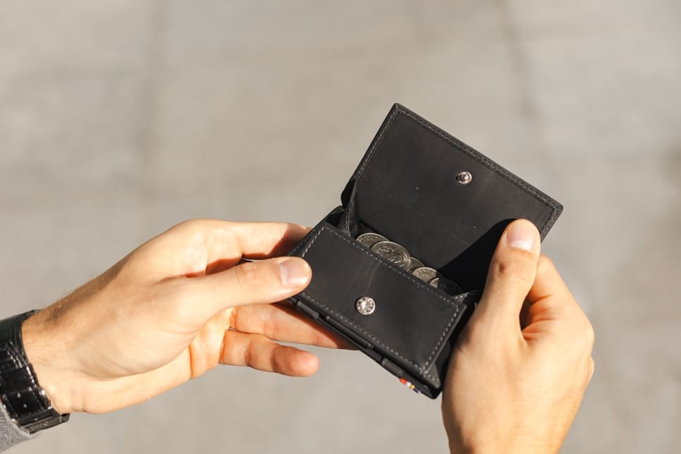 hand holding the coin pocket of the Cavare Magic Coin Wallet