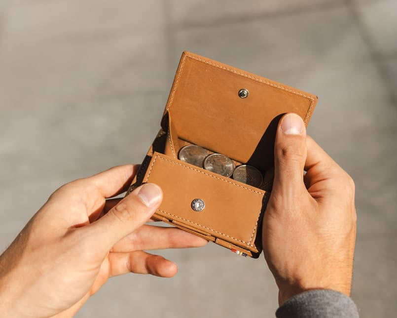 hand holding the coin pocket of the Cavare Magic Coin Wallet