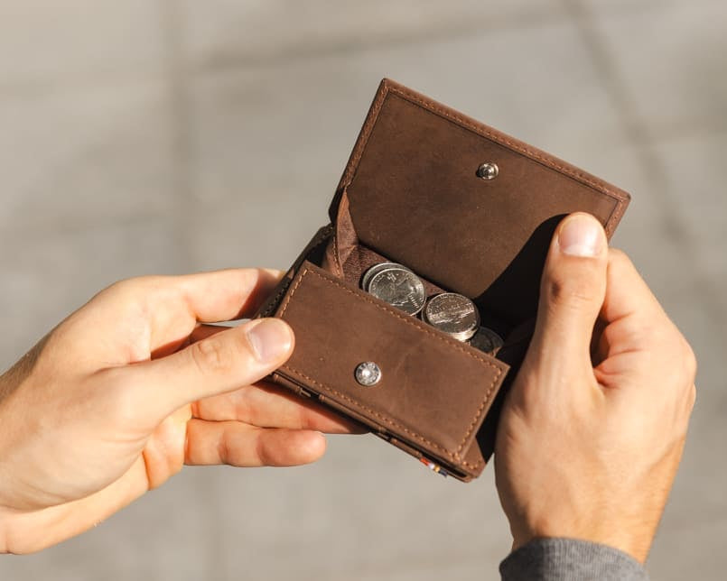 hand holding the coin pocket of the Cavare Magic Coin Wallet