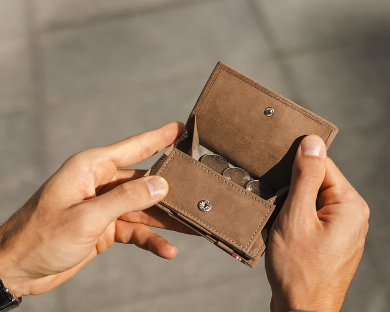 hand holding the coin pocket of the Cavare Magic Coin Wallet