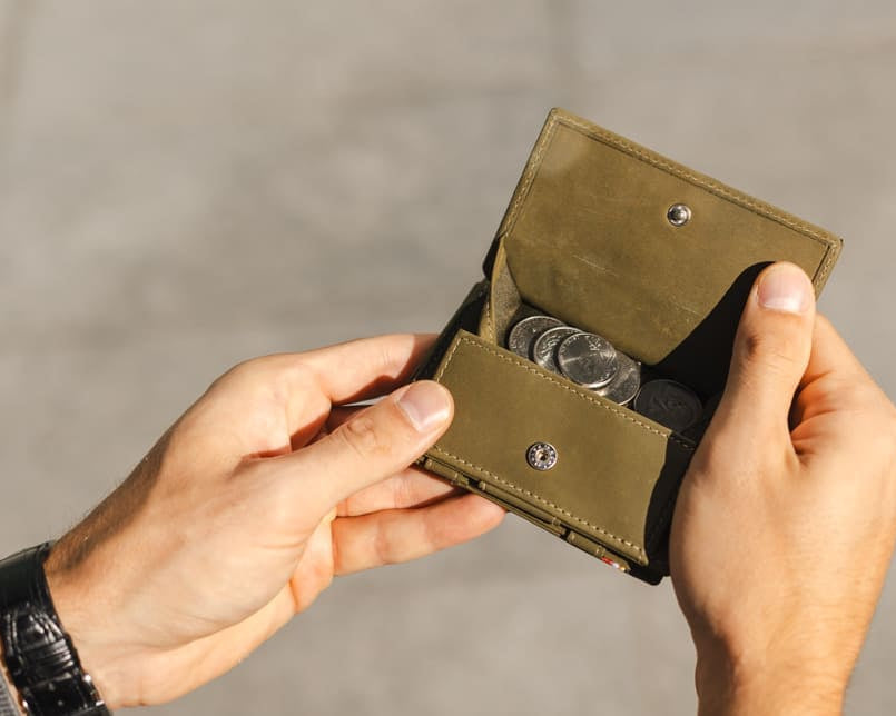 hand holding the coin pocket of the Cavare Magic Coin Wallet