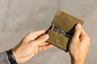 hand holding the coin pocket of the Cavare Magic Coin Wallet