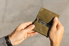 hand holding the coin pocket of the Cavare Magic Coin Wallet 