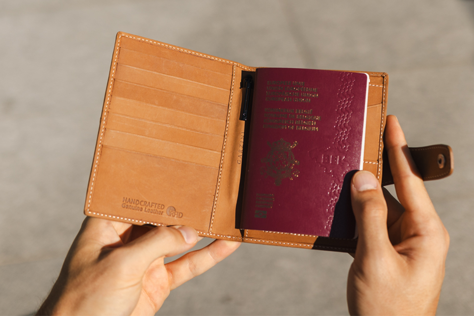 Two hands holding the Vintage Camel Brown open.