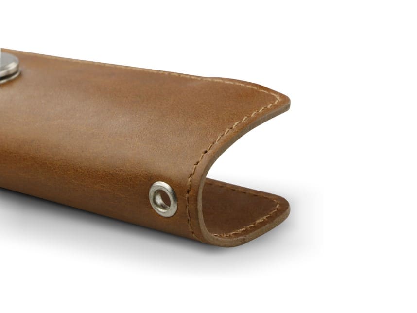 Close up view of the bottom side in Brushed Cognac with a key holder hole for a key holder ring.