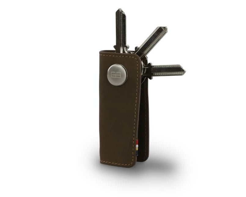 Side view of Lusso Key Holder in Java Brown with with a key holder ring and 3 keys.