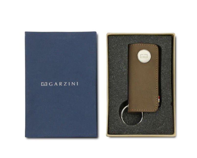 Front view of the Lusso Key Holder in Java Brown in the box with the brand name Garzini. 