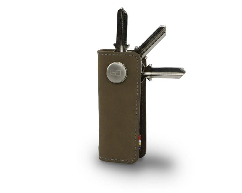 Side view of Lusso Key Holder in Metal Grey with with a key holder ring and 3 keys.