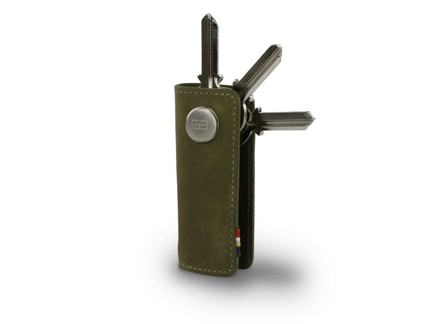 Side view of Lusso Key Holder in Olive Green with with a key holder ring and 3 keys.