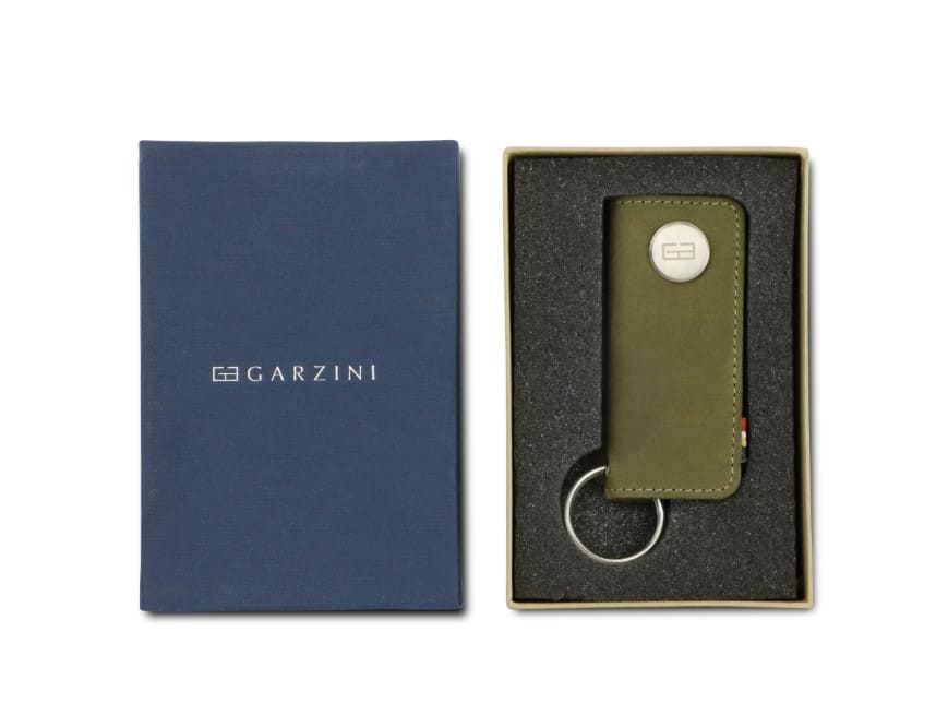 Front view of the Lusso Key Holder in Olive Green in the box with the brand name Garzini.
