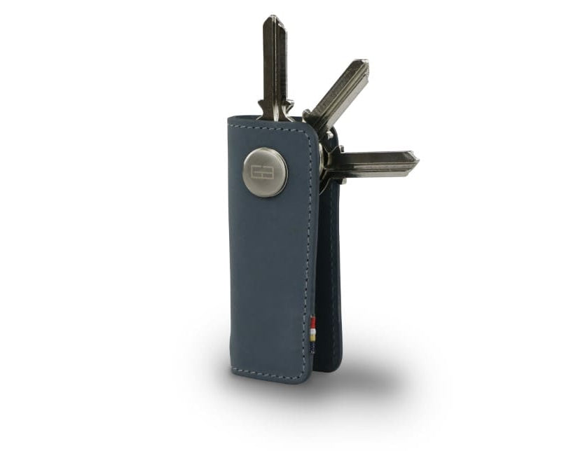 Side view of Lusso Key Holder in Sapphire Blue with with a key holder ring and 3 keys.