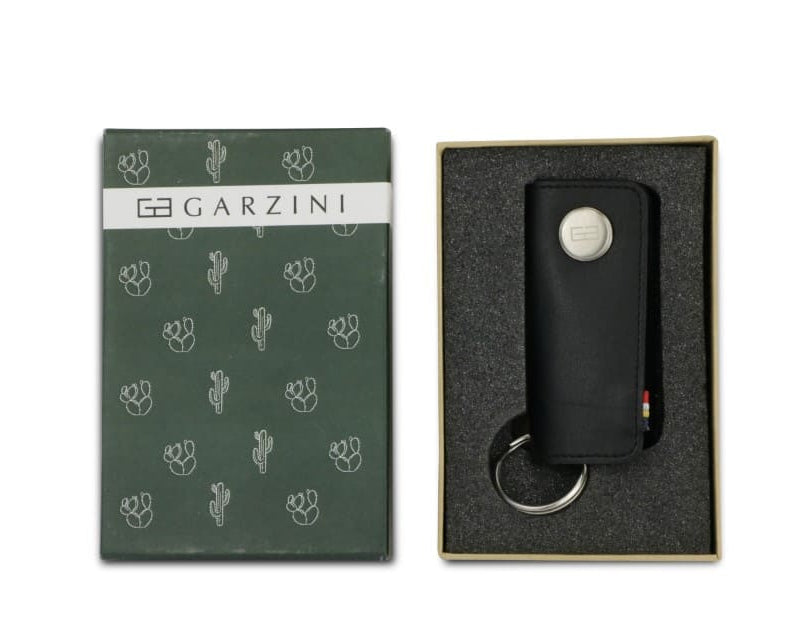 Open green box with the brand name and little cactus icons and front view of the Lusso Key Holder Vegan in Cactus Black in the box