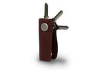 Side view of Lusso Key Holder Vegan in Cactus Burgundy with with a key holder ring and 3 keys.