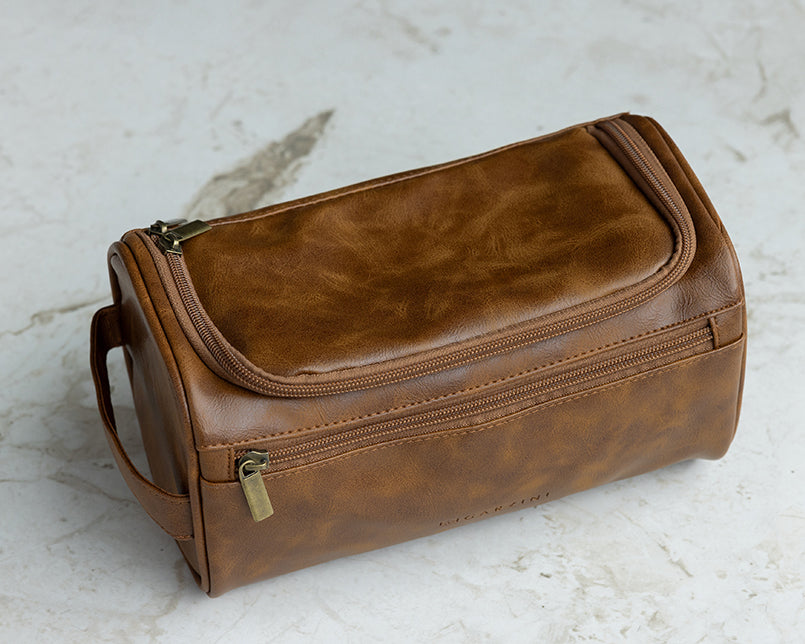 Cognac Garzini Toiletry Bag in a luxury bathroom setting, highlighting its sophisticated design for organizing toiletries.