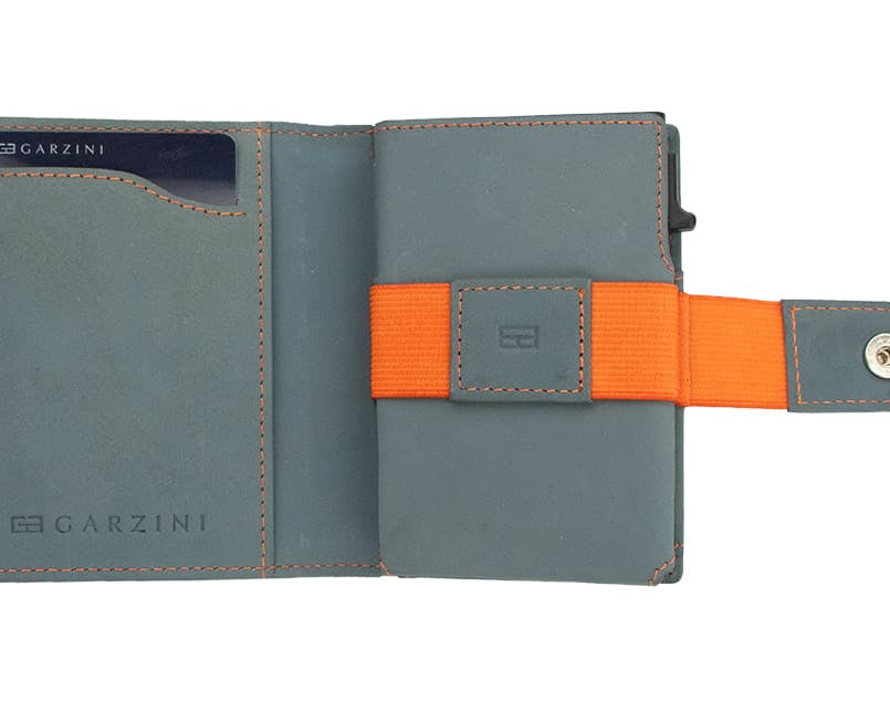 Open Garzini Metal Wallet in blue leather with orange strap, displaying card and cash slots