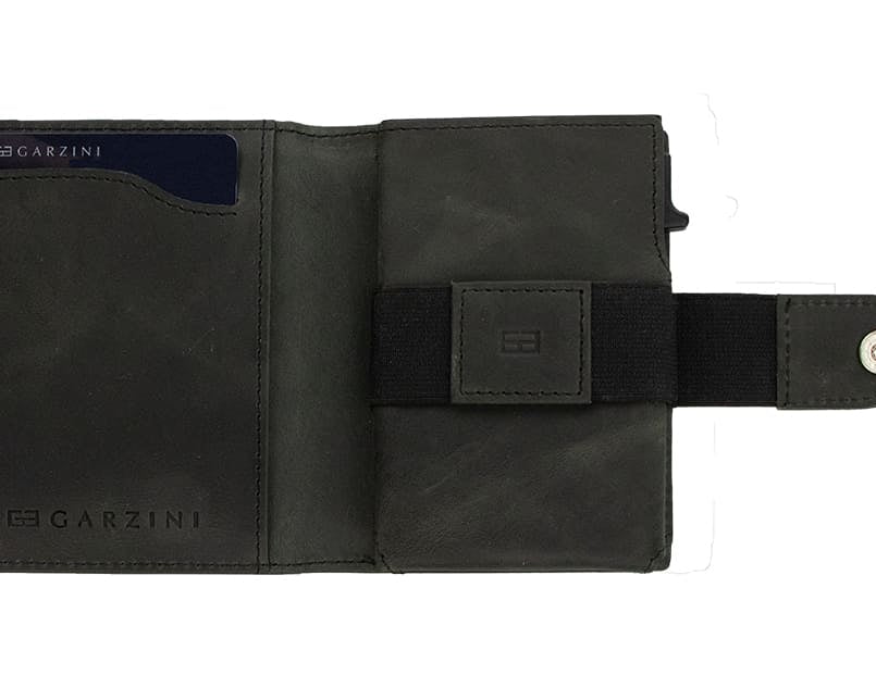 Open Garzini Metal Wallet in brushed black leather, holding a stack of cash