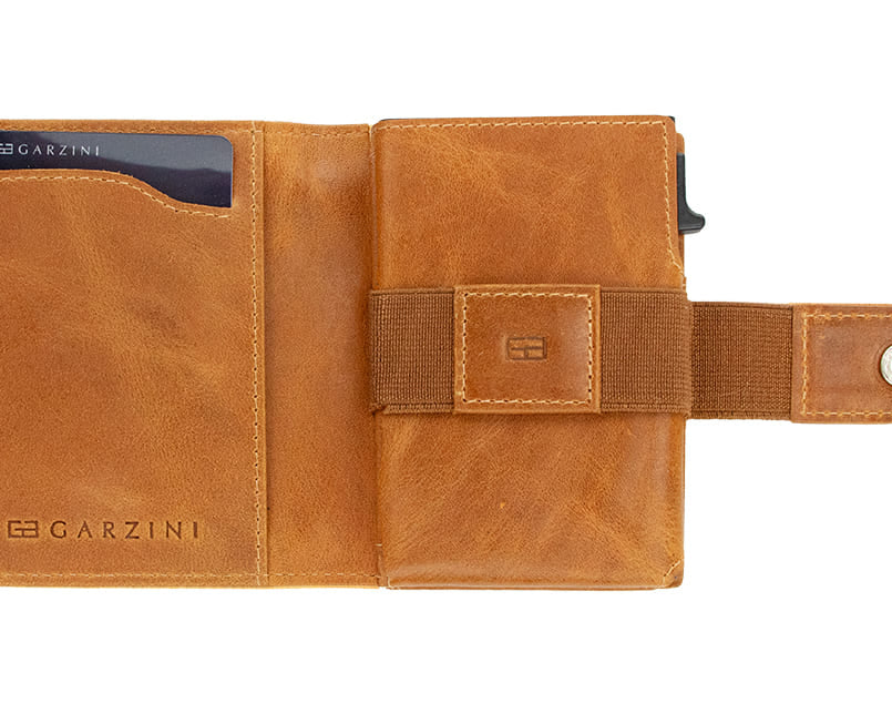 Open Garzini Metal Wallet in brushed cognac leather, displaying card and cash slots