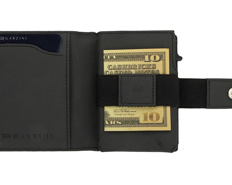Open Garzini Metal Wallet in carbon black leather, holding a stack of cash