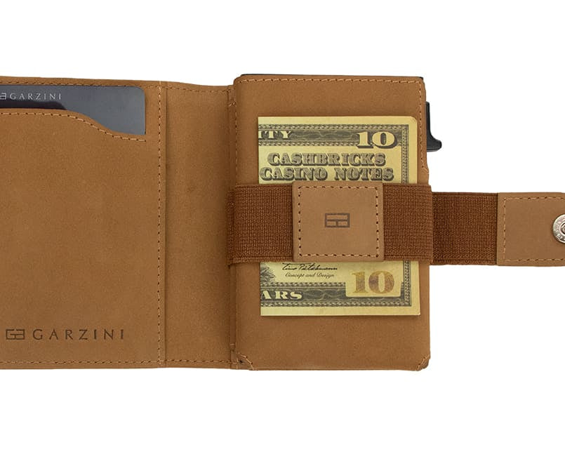 Open Garzini Metal Wallet in camel brown leather, holding a stack of cash