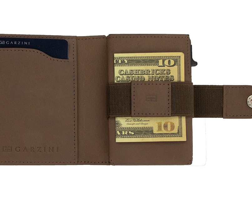 Open Garzini Metal Wallet in java brown leather, holding a stack of cash