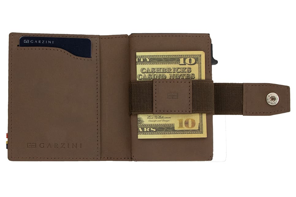 Open Garzini Metal Wallet in java brown leather, holding a stack of cash