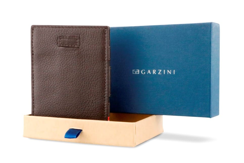 Half-open blue box with Garzini brand name Inside the box, the Chocolate Brown wallet is wrapped in tissue paper, placed in a light cardboard box with a blue strap.