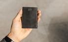 A hand holding the Garzini Cavare Brushed Black  wallet