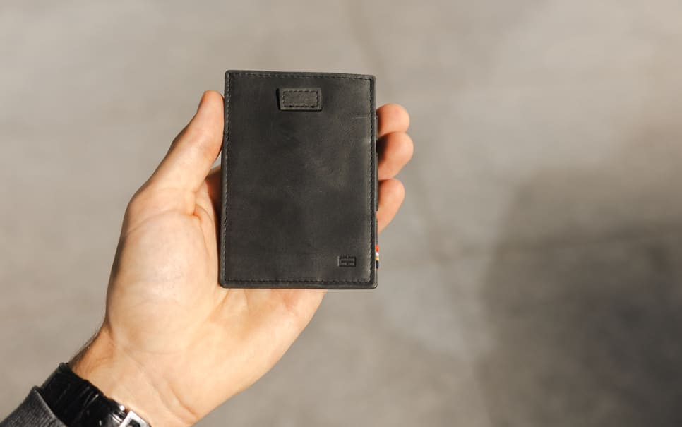 A hand holding the Garzini Cavare Brushed Black  wallet