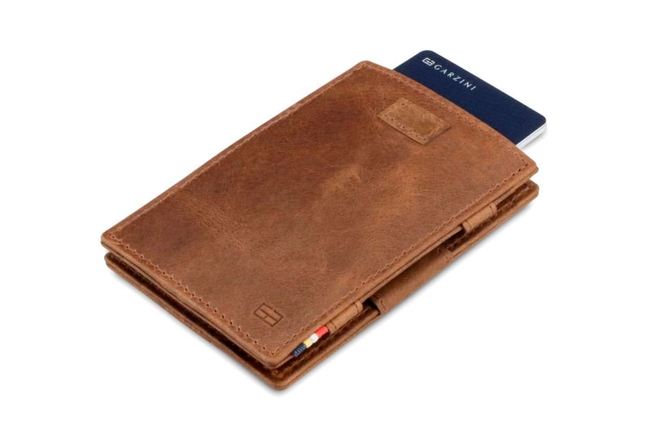 Front view of Cavare Magic Wallet Brushed in Brushed Brown with pull tab and card pulling out.