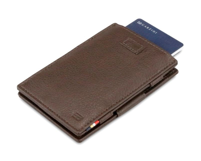 Front view of Cavare Magic Wallet Card Sleeve Nappa in Chocolate Brown with pull tab and card pulling out.