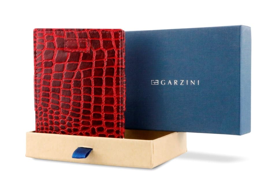 Half-open blue box with Garzini brand name Inside the box, the Garzini wallet is wrapped in tissue paper, placed in a light cardboard box with a blue strap.