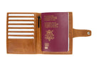 Open view of the AirTag Passport Holder in Brushed Brushed Cognac with cards and passport inside.