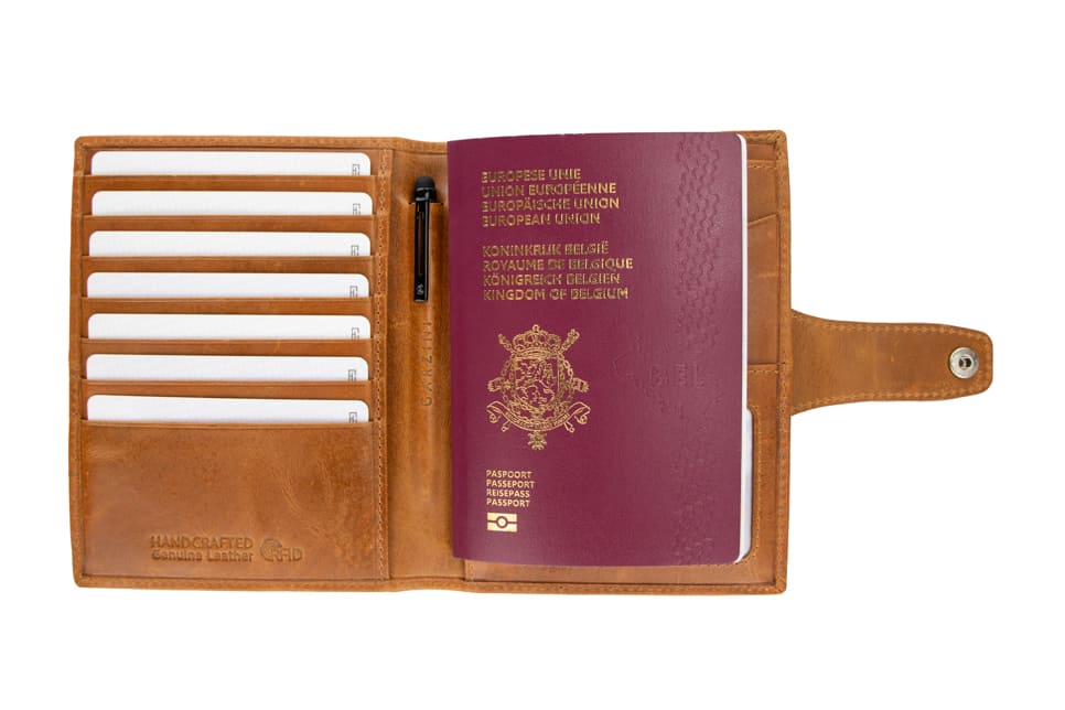Open view of the AirTag Passport Holder in Brushed Brushed Cognac with cards and passport inside.