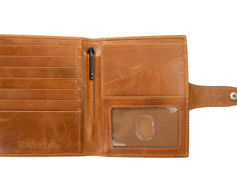 Open view of the AirTag Passport Holder in Brushed Brushed Cognac with no cards.