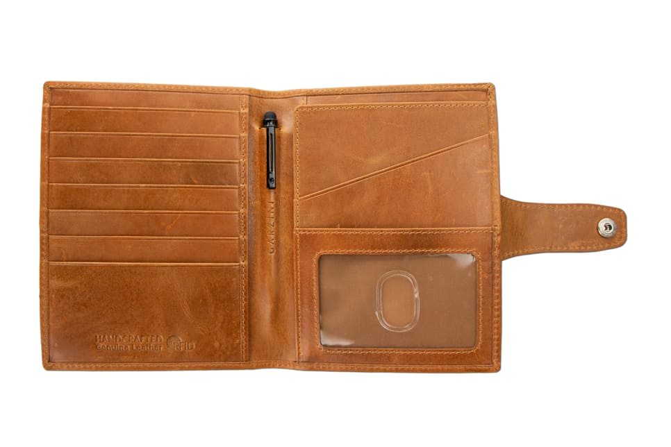 Open view of the AirTag Passport Holder in Brushed Brushed Cognac with no cards.