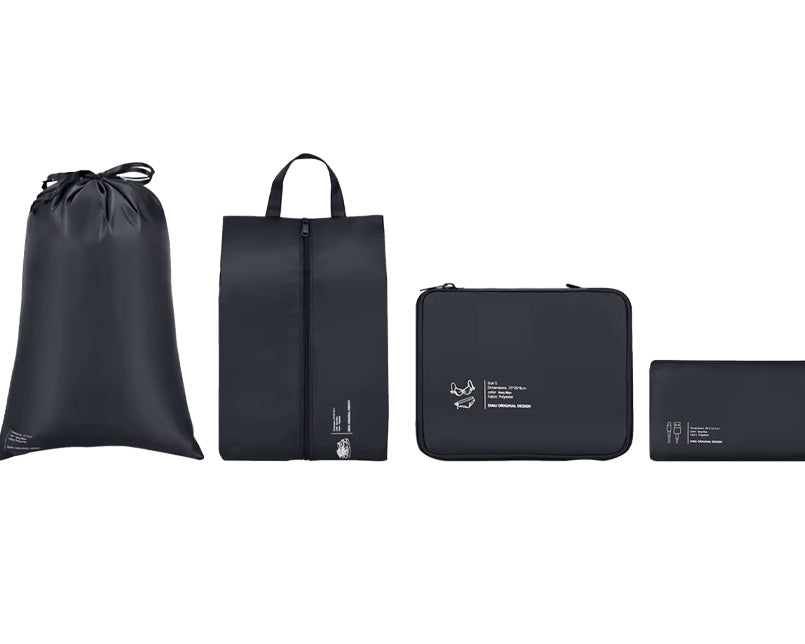 Complete set of Garzini packing cubes with a laundry bag and shoe bag displayed upright