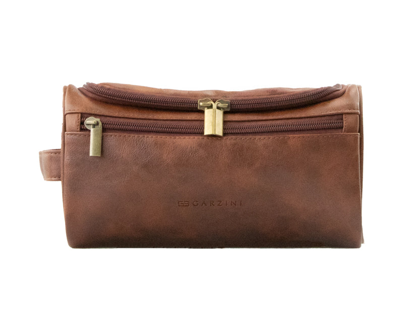 Close-up of Brown Garzini Toiletry Bag front side, highlighting high-quality vegan leather and durable zipper.