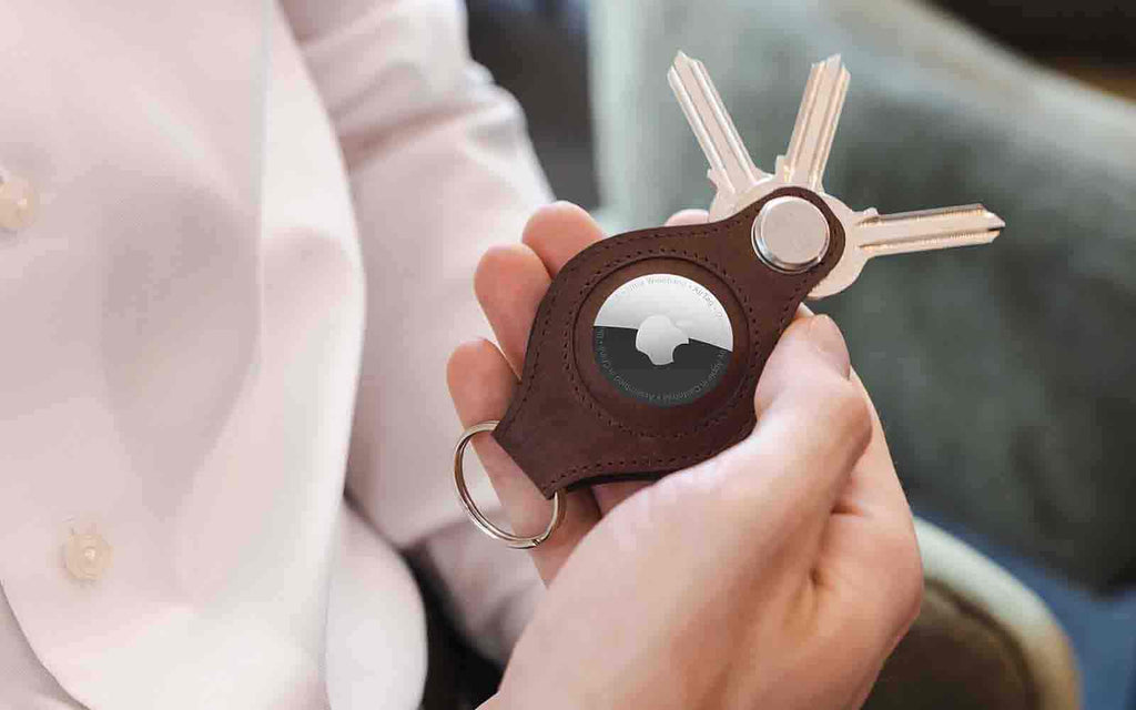 a hand holding the AirTag Key Holder