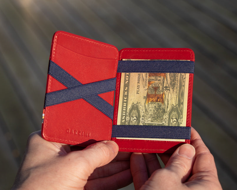 A hand holding the Urban Magic Wallet