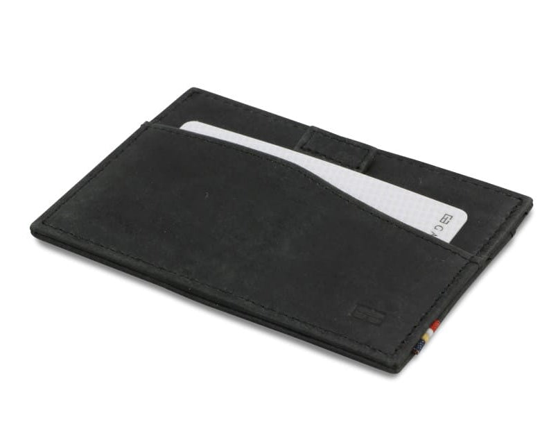 Front view of Leggera Card Holder Brushed in Brushed Black with a pull tab with a card.