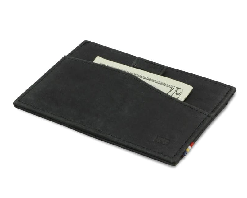 Front view of Leggera Card Holder Brushed in Brushed Black with a pull tab with money.