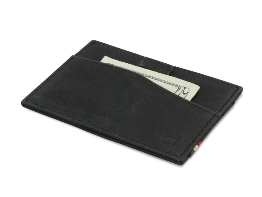 Front view of Leggera Card Holder Brushed in Brushed Black with a pull tab with money.