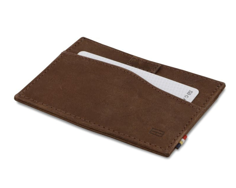 Front view of Leggera Card Holder Brushed in Brushed Brown with a pull tab with a card.