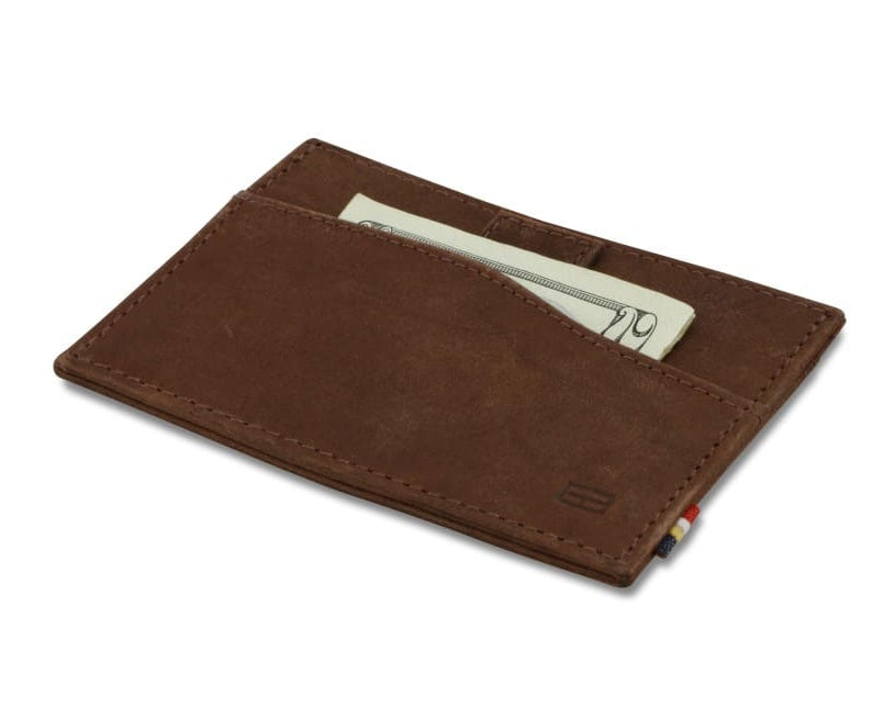 Front view of Leggera Card Holder Brushed in Brushed Brown with a pull tab with money.